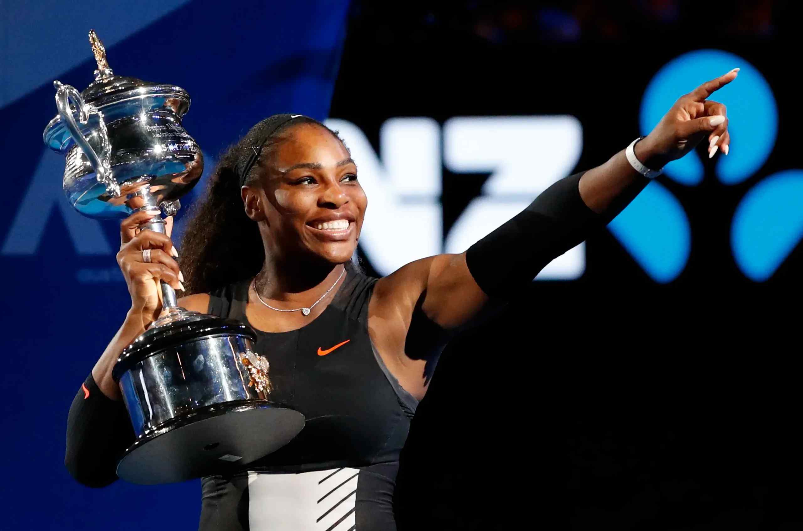 Tennis legend Serena Williams collecting a trophy.